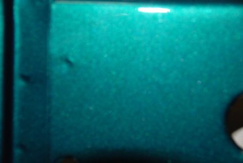 1996 Ford Bronco - This teal painted metal panel shows some minor imperfections and reflections.
