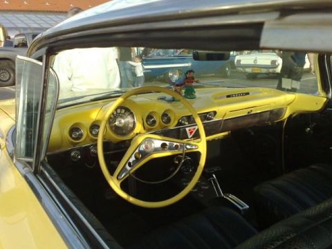 1991 Ford Crown Victoria - Interior view of a vintage car, a bright yellow dashboard and steering wheel with 'IMPALA' badging.