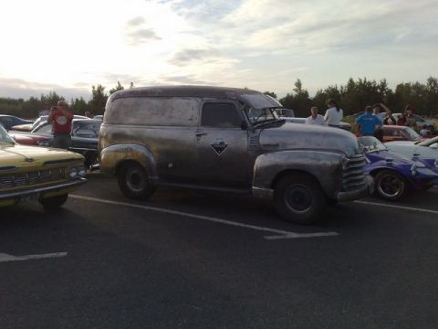 1991 Ford Crown Victoria - A vintage panel van is seen at a car meet with several other vehicles in the background.