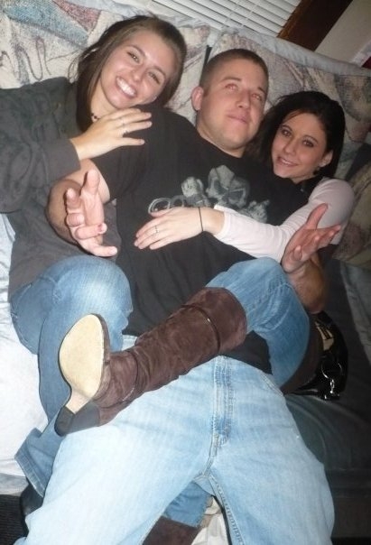 1996 Ford Bronco - A group of three people are posing together on a couch.