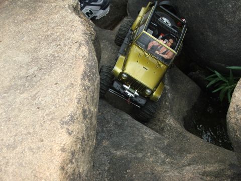 1996 Ford Bronco - RC rock crawler Jeep maneuvering through a challenging rocky obstacle course.