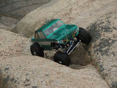 1996 Ford Bronco - RC rock crawler navigating a rocky terrain.