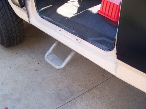1986 Ford Bronco - Interior step and tire visible from the side of a vehicle.