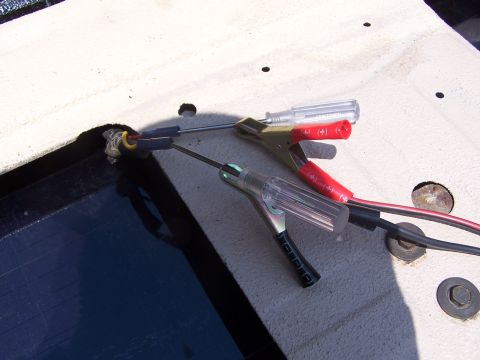 1986 Ford Bronco - Close-up of electrical testing equipment connected to a wire.