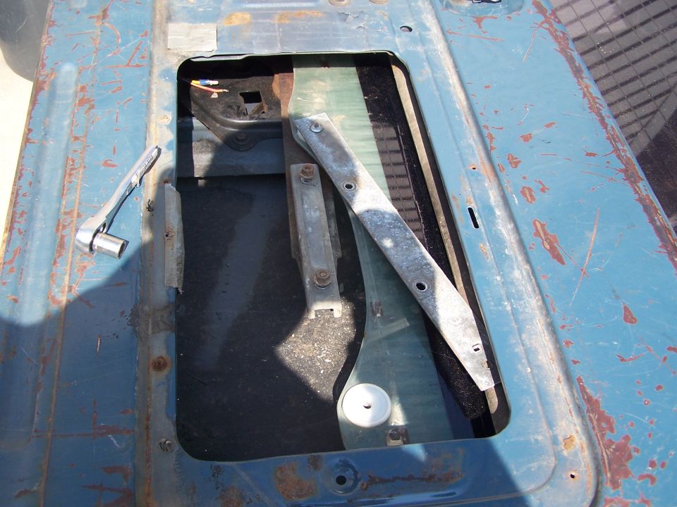 Tailgate interior with window mechanism and socket wrench