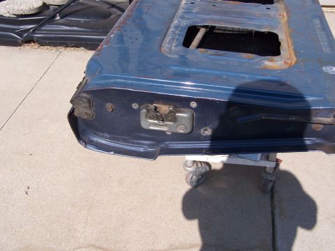 1986 Ford Bronco - The interior of a vehicle's tailgate shows the latch mechanism and surrounding metalwork.