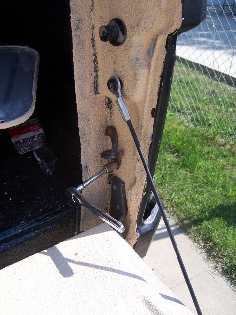 1986 Ford Bronco - A socket wrench is used to adjust the tailgate latch mechanism on a vehicle.