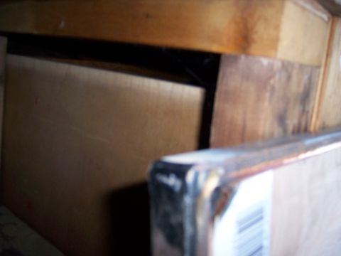 1991 Ford Bronco - A metal object with a barcode is partially visible in the foreground, with wooden surfaces in the background.