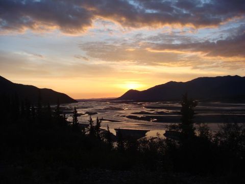 2001 Chevrolet Corvette - Sunset over a wide river delta with mountains in the distance.