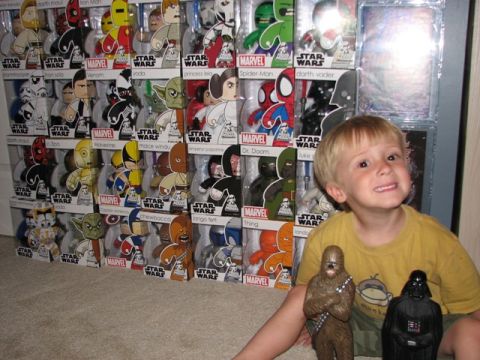 1991 Ford Bronco - A young boy poses with action figures in front of a large collection of Star Wars and Marvel toys.