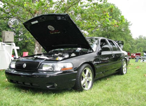 2003 Mercury Marauder - Black 2003 Mercury Marauder at a car show, hood open to reveal the engine and a "Supercharged" emblem.