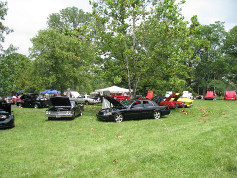 2003 Mercury Marauder - A black 2003 Mercury Marauder is displayed with its hood open at an outdoor car show.