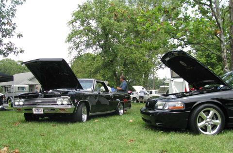 2003 Mercury Marauder - A black 2003 Mercury Marauder is parked on the grass with its hood open at an outdoor car show.