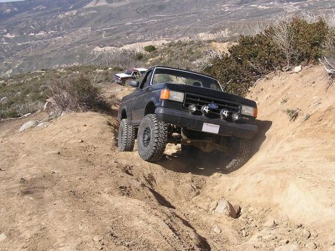 1990 Ford Bronco - Off-roading in a 1990 Ford Bronco on a challenging mountain trail.