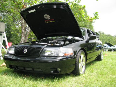 2003 Mercury Marauder - A black 2003 Mercury Marauder is displayed with its hood open, revealing the engine and a "Marauder Supercharged" emblem on the underside o…