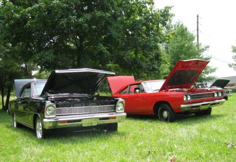 2003 Mercury Marauder - Two vintage cars, a black one and a red one, are parked on a lawn with their hoods raised.