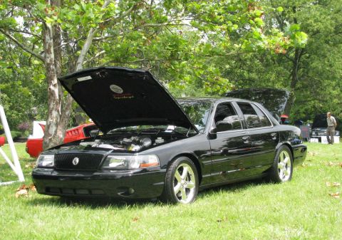 2003 Mercury Marauder - A black 2003 Mercury Marauder is displayed with its hood open, revealing a supercharger under the hood.