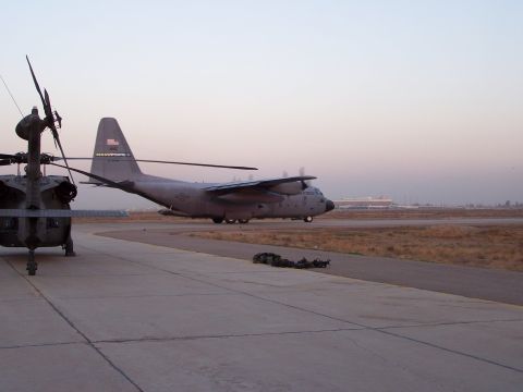 1995 Ford Bronco - Military aircraft on a tarmac at dusk, with a helicopter and a transport plane visible.