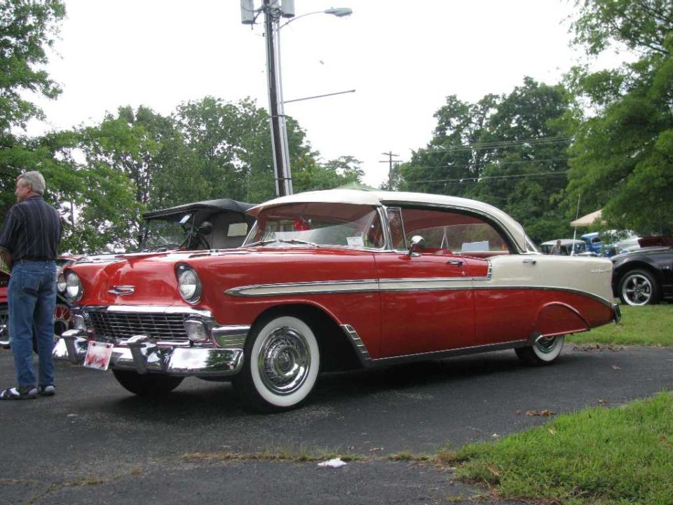Red and white 1956 two-door hardtop, side view
