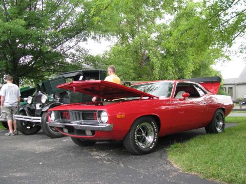 2003 Mercury Marauder - A red muscle car is displayed with its hood open at an outdoor car event.