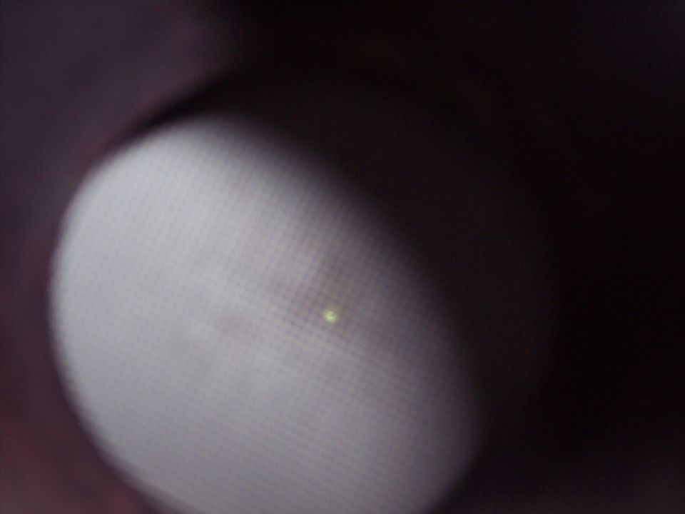 Close-up of a textured surface with a small light reflection