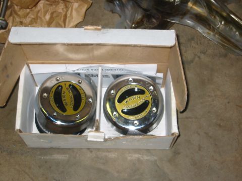 1995 Ford Bronco - A pair of Warn locking hubs are presented in their original packaging, ready for installation.
