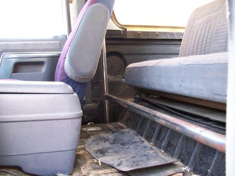 1990 Ford Bronco - Interior view of a vehicle, highlighting the roll cage, seats, and center console. The registry claims it is a 1990 Ford Bronco, but this i…