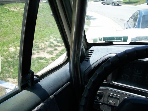 1990 Ford Bronco - A roll cage is visible inside the vehicle's interior, obscuring the view of the dashboard and steering wheel.