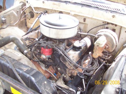 1979 Ford Bronco - Close-up view of a vehicle's engine bay, showing the air cleaner, distributor, and brake booster.