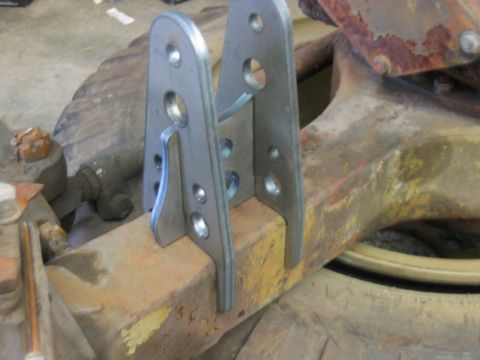1992 Ford Mustang - Custom metal brackets are attached to a rusty axle, suggesting a modification or repair.