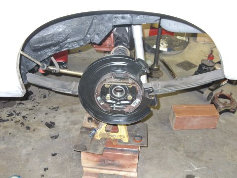 1978 Ford Mustang II - Close-up view of a vehicle's rear drum brake assembly, showing suspension components and brake hardware.