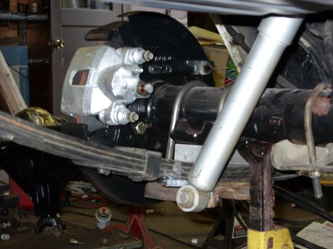 1978 Ford Mustang II - Close-up view of a vehicle's rear axle assembly, highlighting the brake caliper and suspension components.
