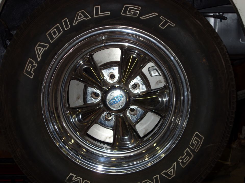 Chrome Cragar five-spoke mag wheel with blue center cap on a Radial T/A tire
