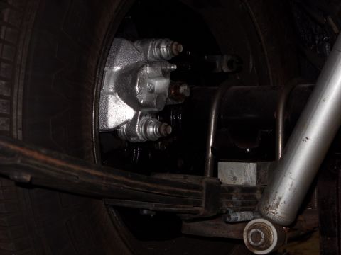 1978 Ford Mustang II - Close-up view of a vehicle's rear suspension and braking system components.