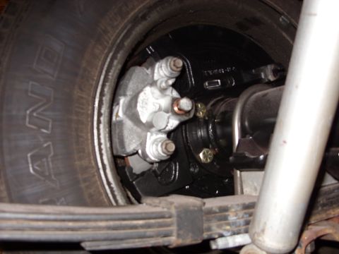1978 Ford Mustang II - Close-up view of a vehicle's rear drum brake assembly, showing the caliper and leaf springs.