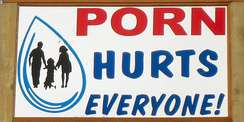 Sign with red text 'PORN HURTS EVERYONE!' and a blue outline of a water drop containing a family silhouette