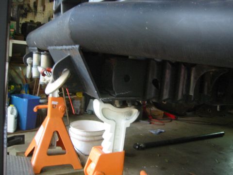 1995 Ford Bronco - The vehicle's undercarriage is visible, supported by jack stands in a garage setting.