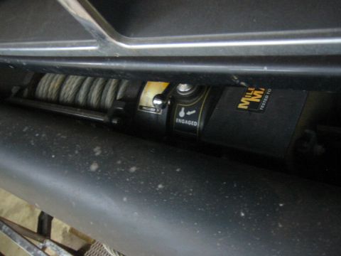 1995 Ford Bronco - Close-up of a vehicle winch, showing operational labels and manufacturer markings.