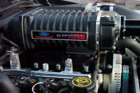 2003 Ford Crown Victoria - Close-up view of a supercharged engine, highlighting the Ford Racing Whipple unit and other engine parts.