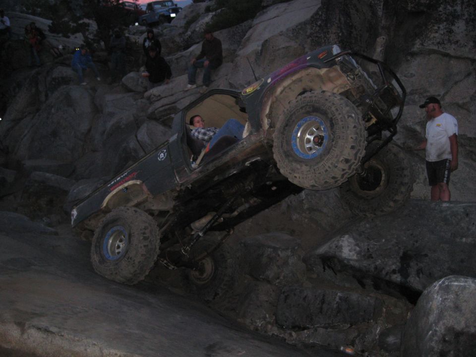 Off-road vehicle climbing rocks, driver inside
