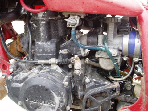 2000 Ford E350 - Close-up view of a motorcycle engine, showing the carburetor and "Honda" branding on the crankcase.