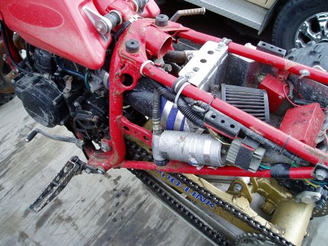 2000 Ford E350 - Motorcycle frame and engine components, including an air filter and "PRO-LINK" suspension system.