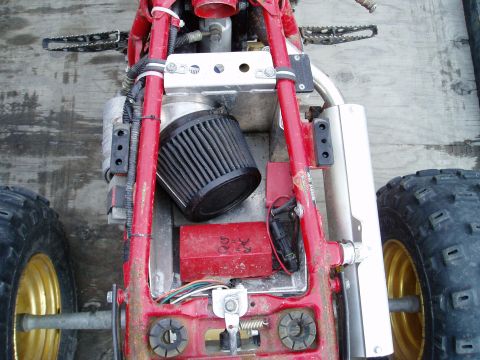 2000 Ford E350 - The internal components of a red ATV are visible, including the air filter and exhaust system.