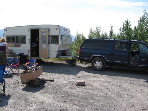 1978 Ford Bronco - A camper trailer and SUV are parked side-by-side in a remote outdoor setting.
