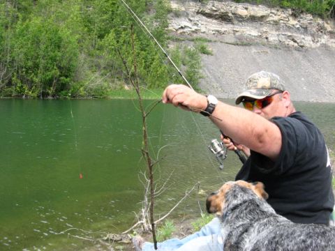 1978 Ford Bronco - Man and his dog enjoy a day of fishing by the water.
