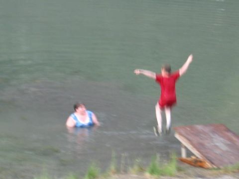 1978 Ford Bronco - A person jumps into the water while another person watches from the water.
