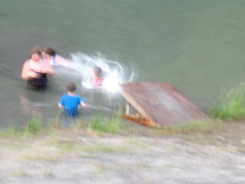1978 Ford Bronco - People enjoy a day swimming in the water by a wooden ramp.