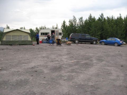 1978 Ford Bronco - A campsite scene includes a blue sedan, a dark SUV, a tent, and an RV under a cloudy sky.