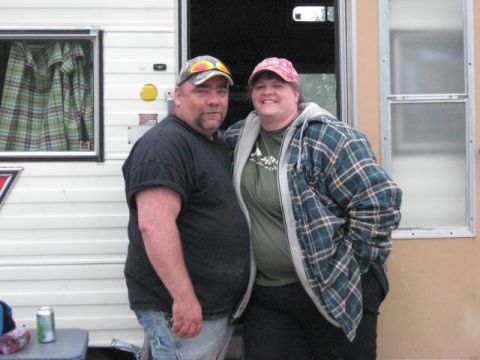 1978 Ford Bronco - Couple stands together in front of a trailer, possibly during a camping trip.