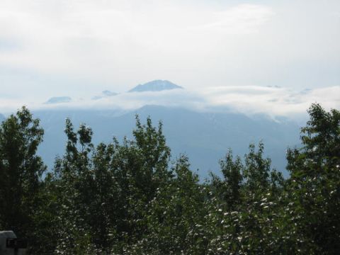 1978 Ford Bronco - A scenic view of mountains and trees under a cloudy sky.